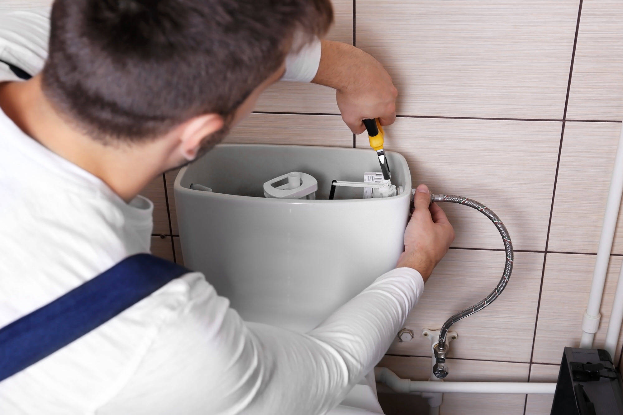 Plumber Hamilton repairing toilet cistern