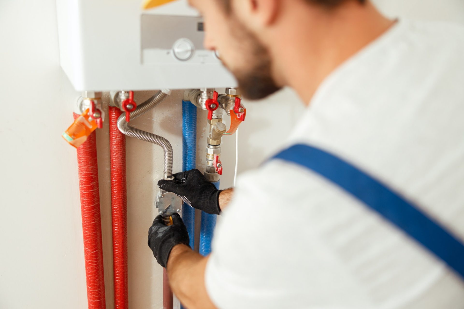 plumber fixing gas hot water system