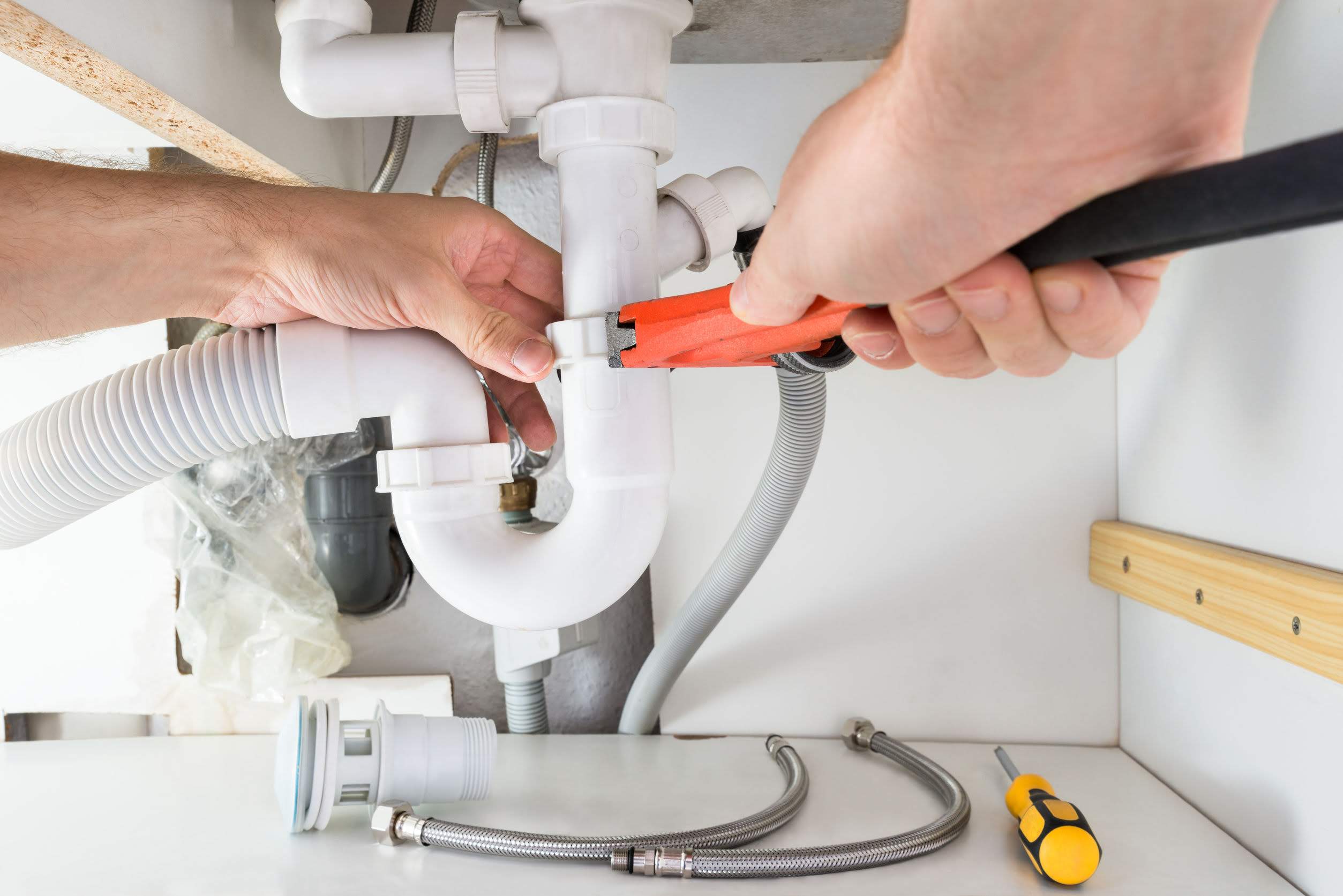 Plumber fixing sink