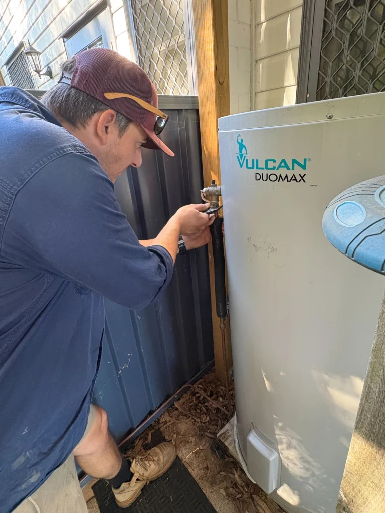 Matthew O'Sullivan servicing hot water heater