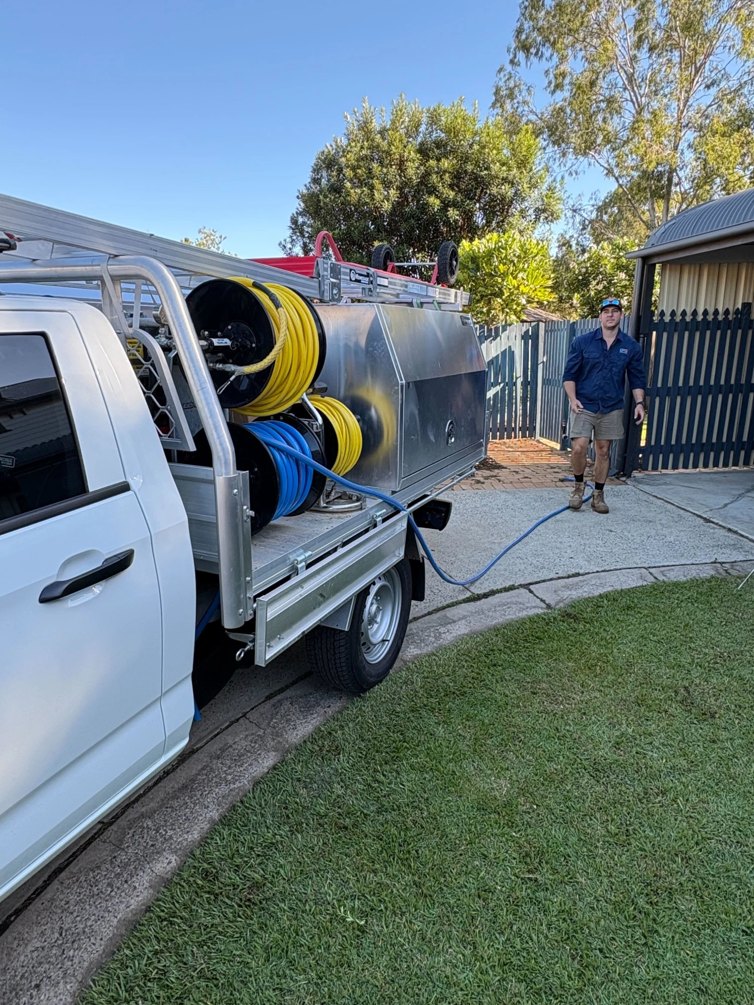 Professional plumber from OPG Services fixing pipes in Brisbane home